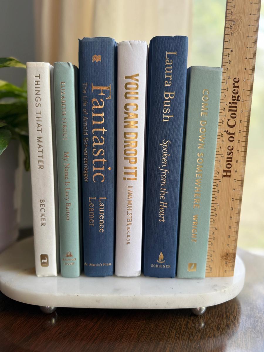 Curated collection of layered blue books ranging from pale coastal blue to deeper ocean tones.