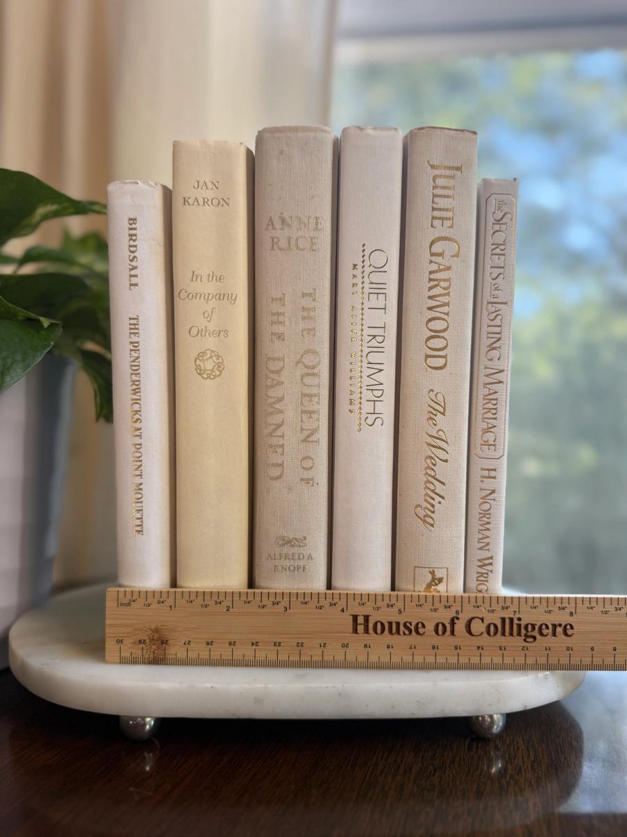 Curated collection of crisp white, ivory, and warm cream books with soft neutral tones.