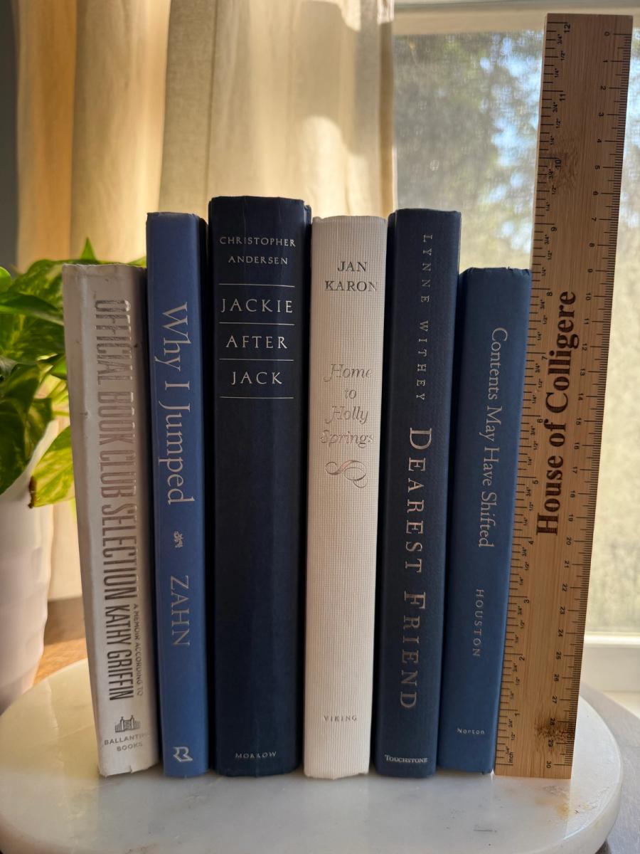 Curated collection of layered blue books ranging from pale coastal blue to deeper ocean tones.