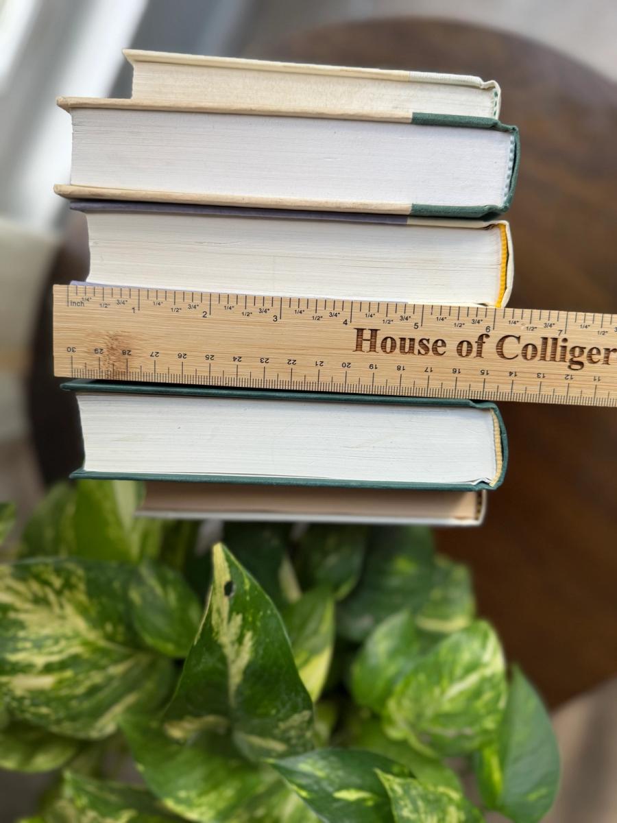 Curated collection of soft sage, olive, cream, and muted green books with botanical tones.