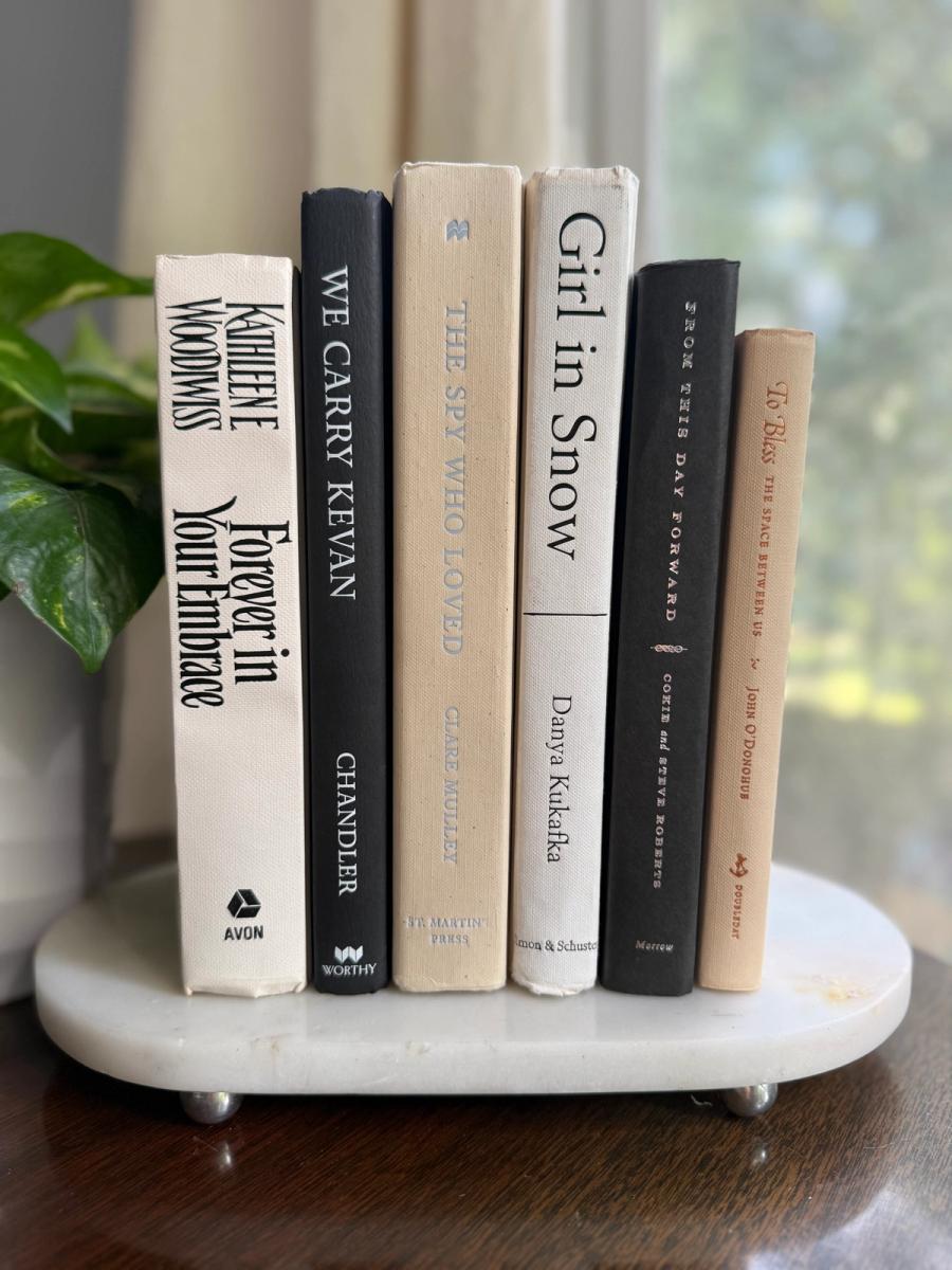 Curated collection of parchment, cream, warm beige, and black books with soft neutral contrast and classic detailing.