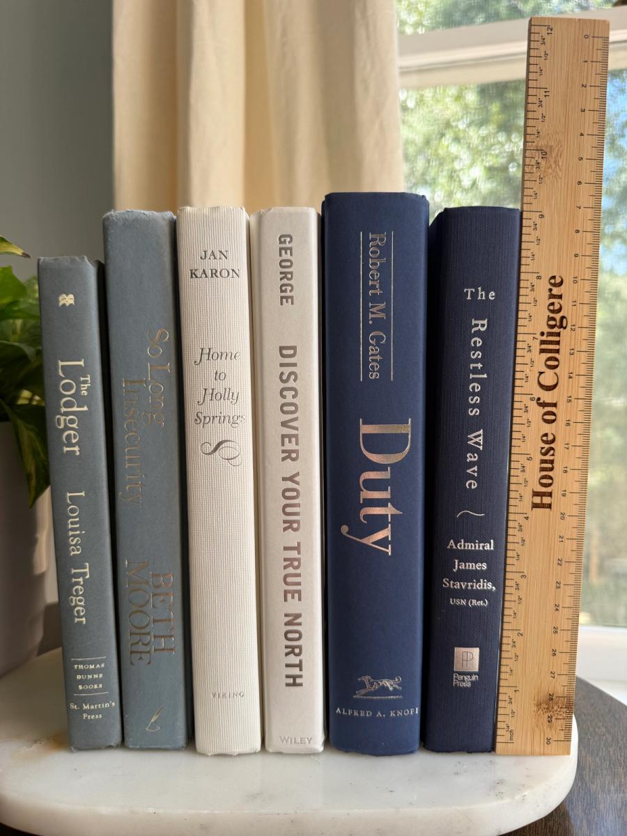 Curated collection of layered blue books ranging from pale coastal blue to deeper ocean tones.