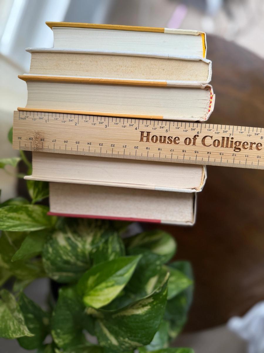 Six white, ivory, and pale taupe hardcover books tied with natural ribbon on a marble tray, with gold-toned lettering and a Linen No. 10 card.