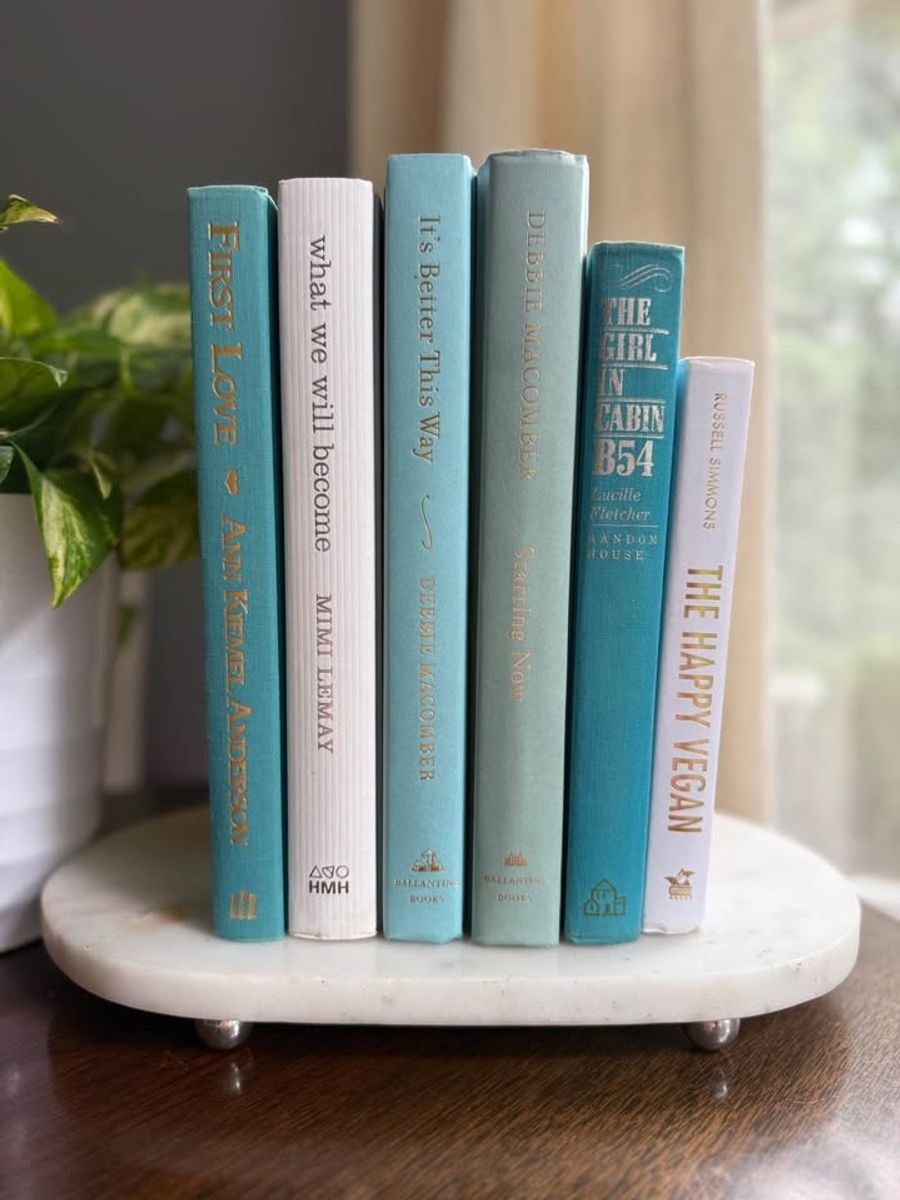 Curated collection of soft blue, aqua, seafoam, and muted coastal-toned books.