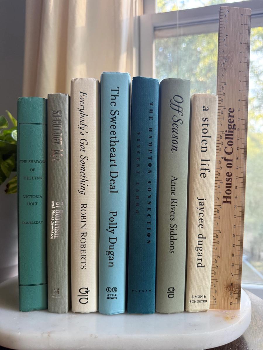 Curated collection of white, pale blue, sand, and soft coastal-neutral books with an airy, sun-faded look.