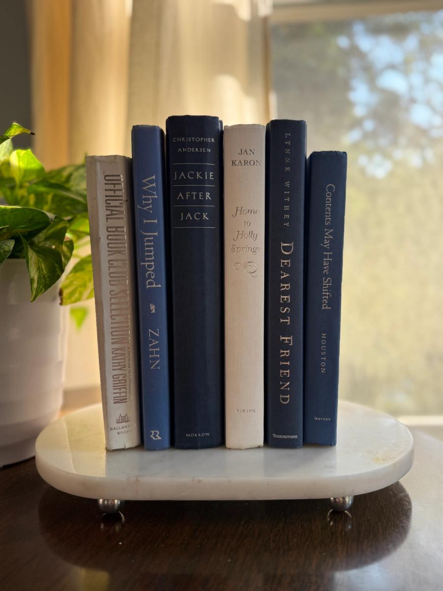 Curated collection of layered blue books ranging from pale coastal blue to deeper ocean tones.
