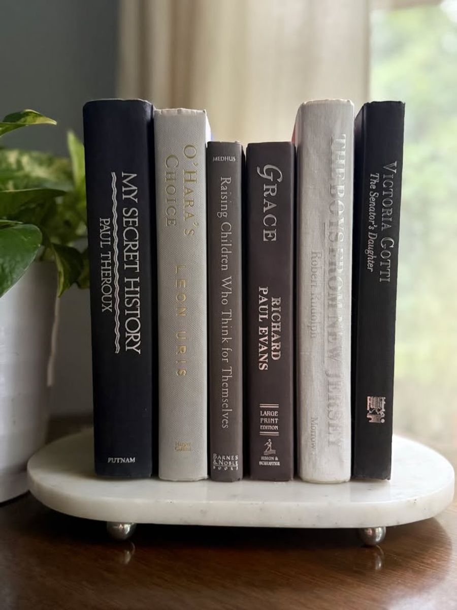 Curated collection of warm brown, olive, tan, and aged neutral books with a traditional library palette.