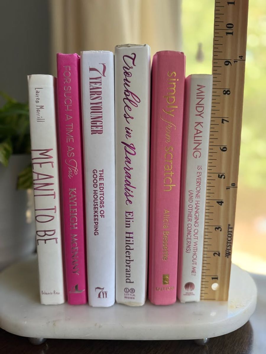 Modernist Edit No. 9 decorative book collection in vivid pink, white, and soft blush tones, tied with neutral linen ribbon and styled on a marble table.