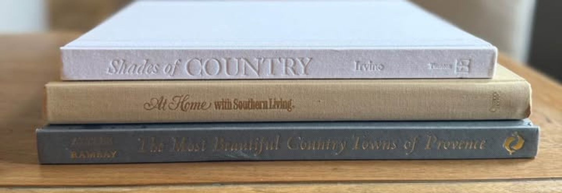 Curated set of oversized hardcover coffee table books selected to work together in scale, color, and visual character.