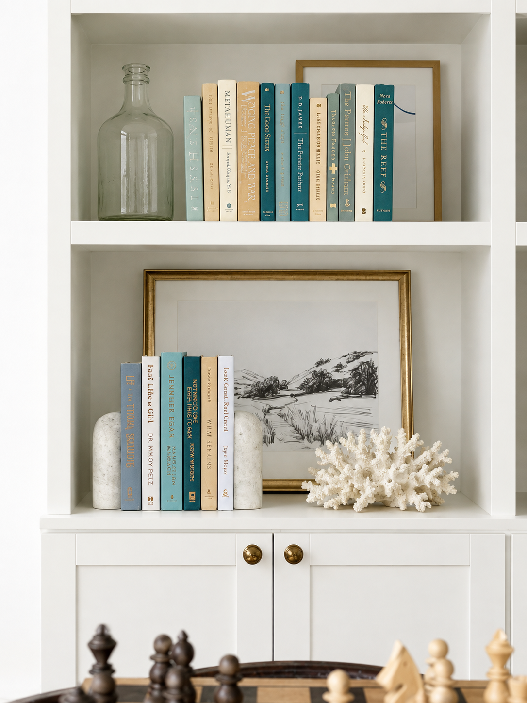 Curated collection of white, pale blue, sand, and soft coastal-neutral books with an airy, sun-faded look.