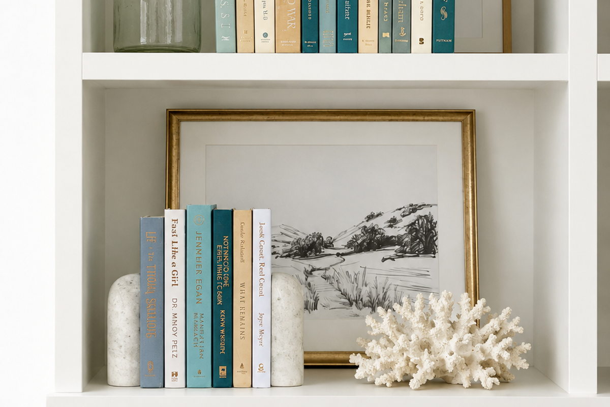 Curated collection of white, pale blue, sand, and soft coastal-neutral books with an airy, sun-faded look.