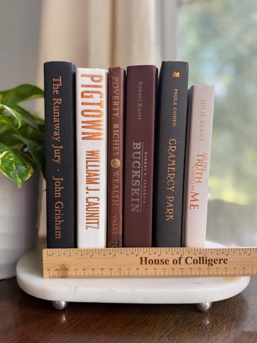Curated collection of warm brown, olive, tan, and aged neutral books with a traditional library palette.