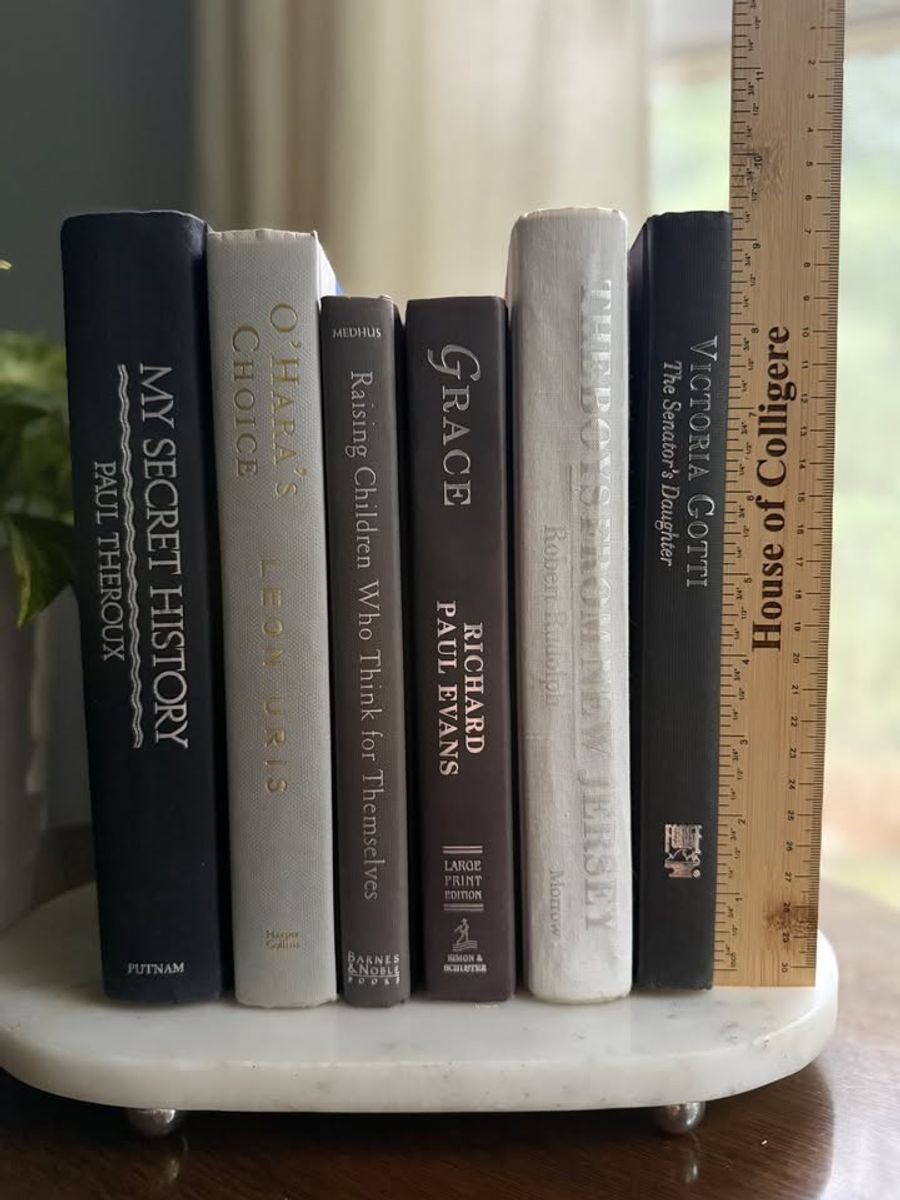 Curated collection of warm brown, olive, tan, and aged neutral books with a traditional library palette.