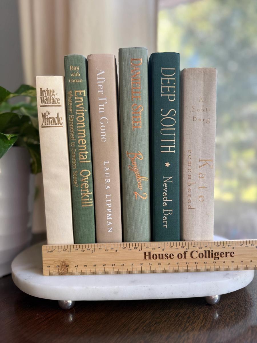 Curated collection of soft sage, olive, cream, and muted green books with botanical tones.