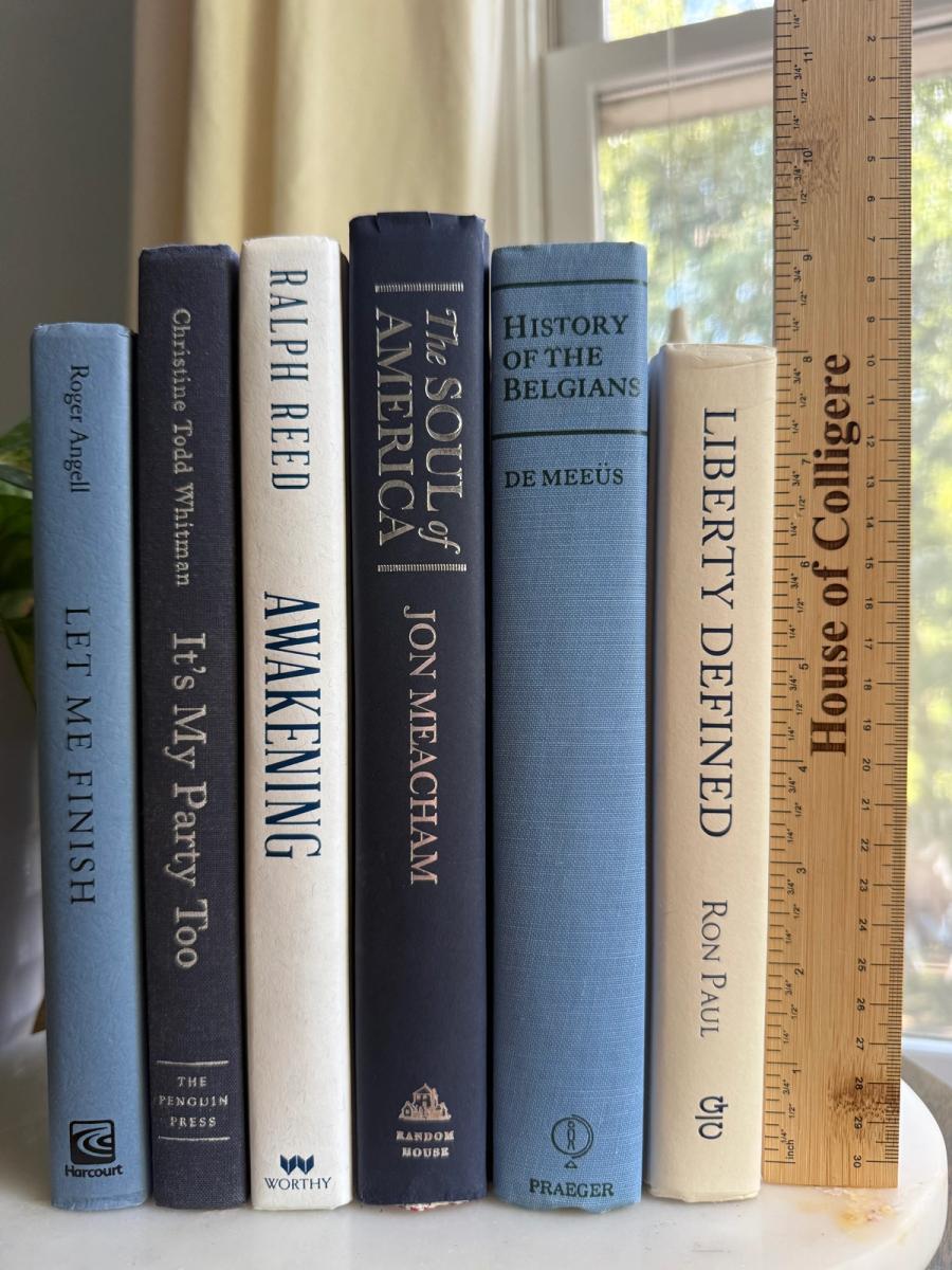 Curated collection of layered blue books ranging from pale coastal blue to deeper ocean tones.
