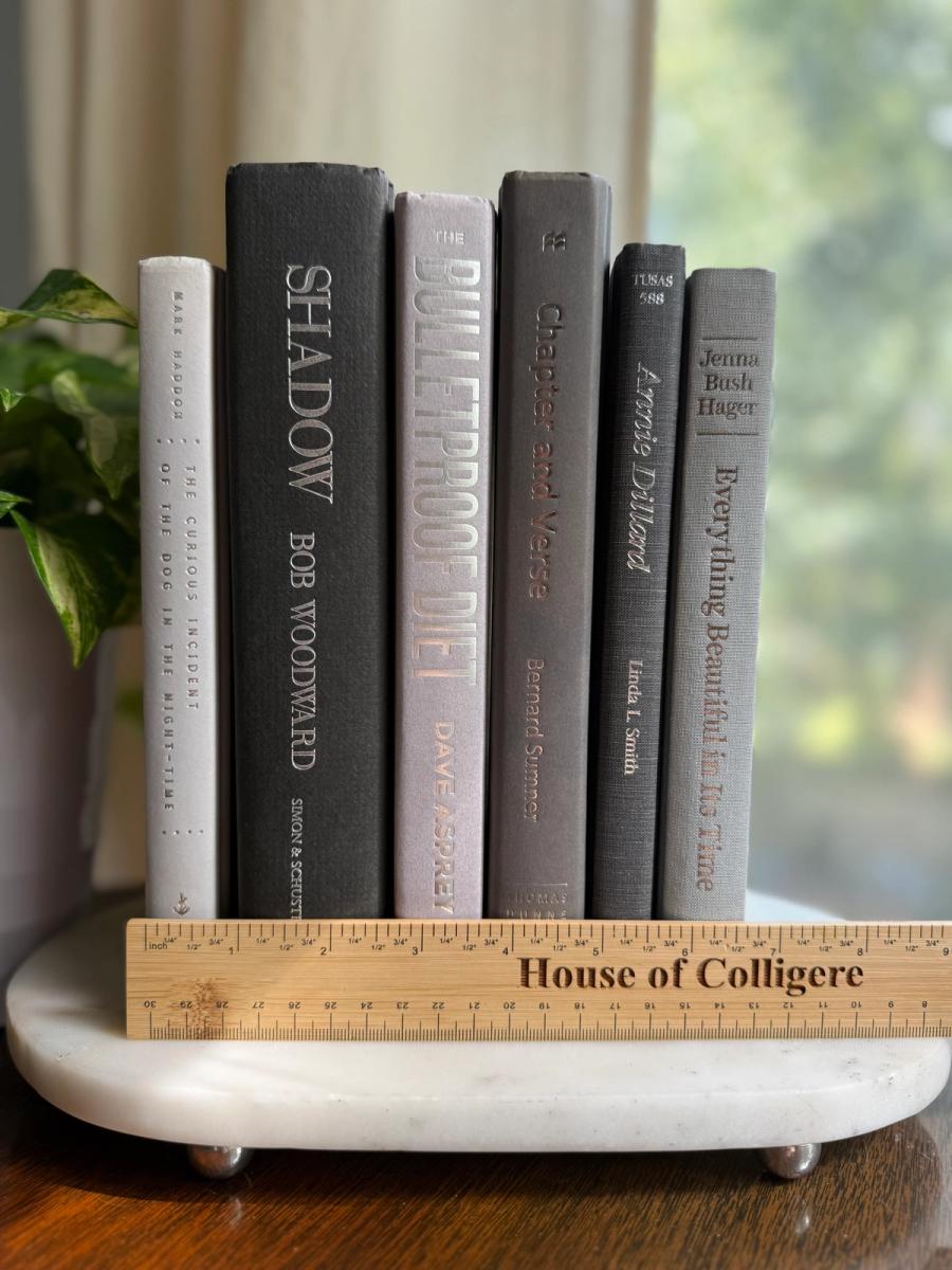 Curated collection of soft white, pale gray, warm greige, and stone-toned books with subtle tonal variation.