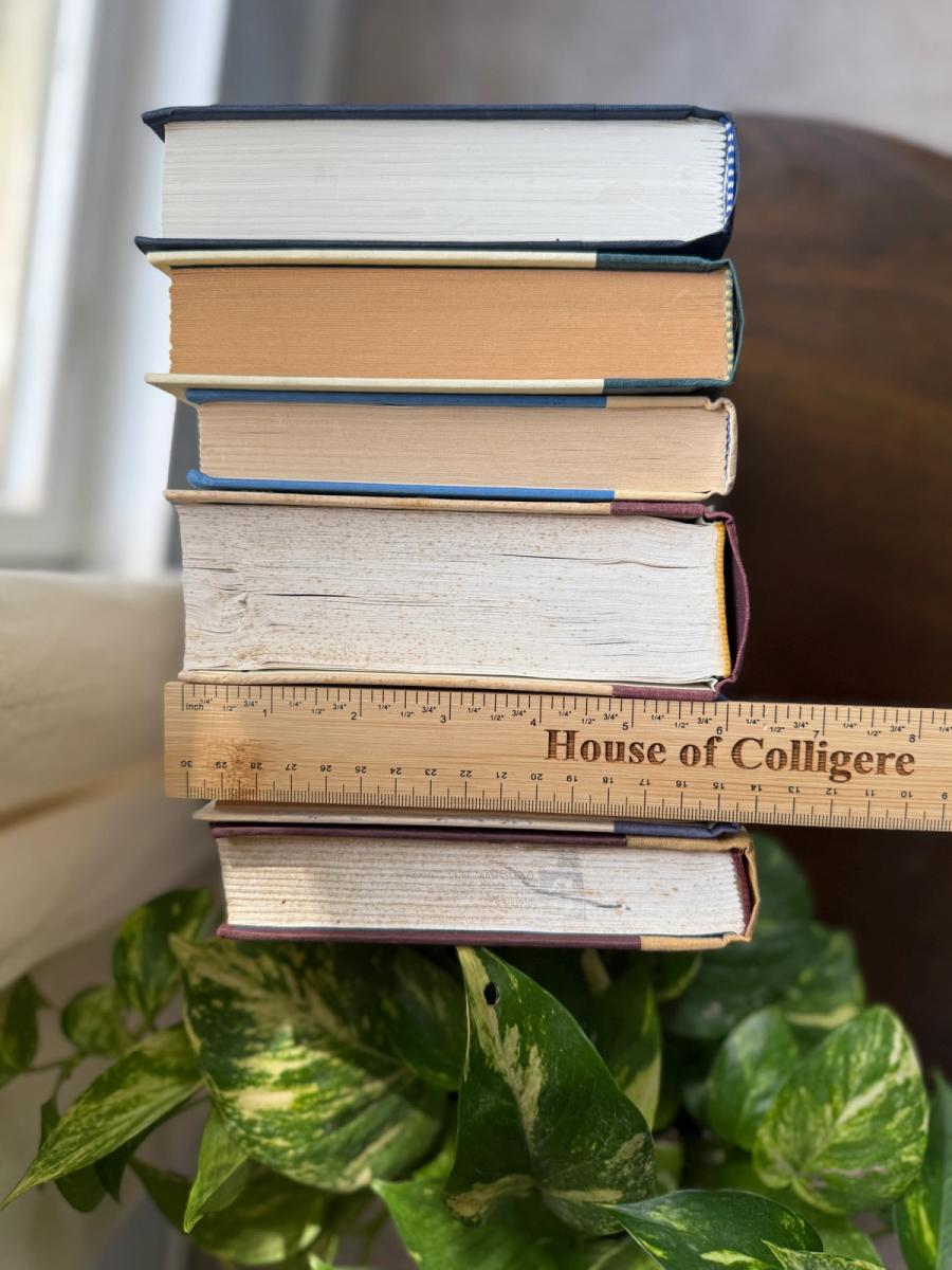 Curated collection of rich brown, hunter green, deep navy, and warm ivory books with classic gold accents.