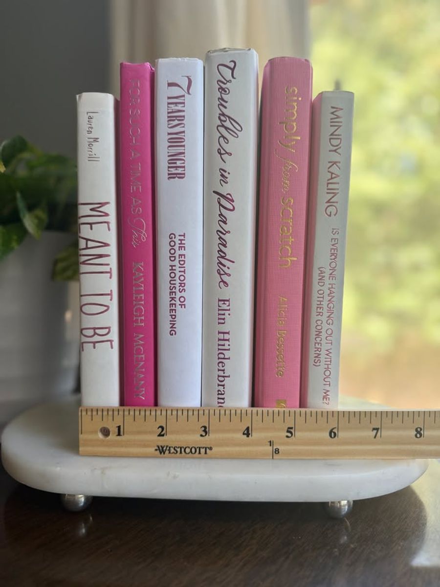 Modernist Edit No. 9 decorative book collection in vivid pink, white, and soft blush tones, tied with neutral linen ribbon and styled on a marble table.