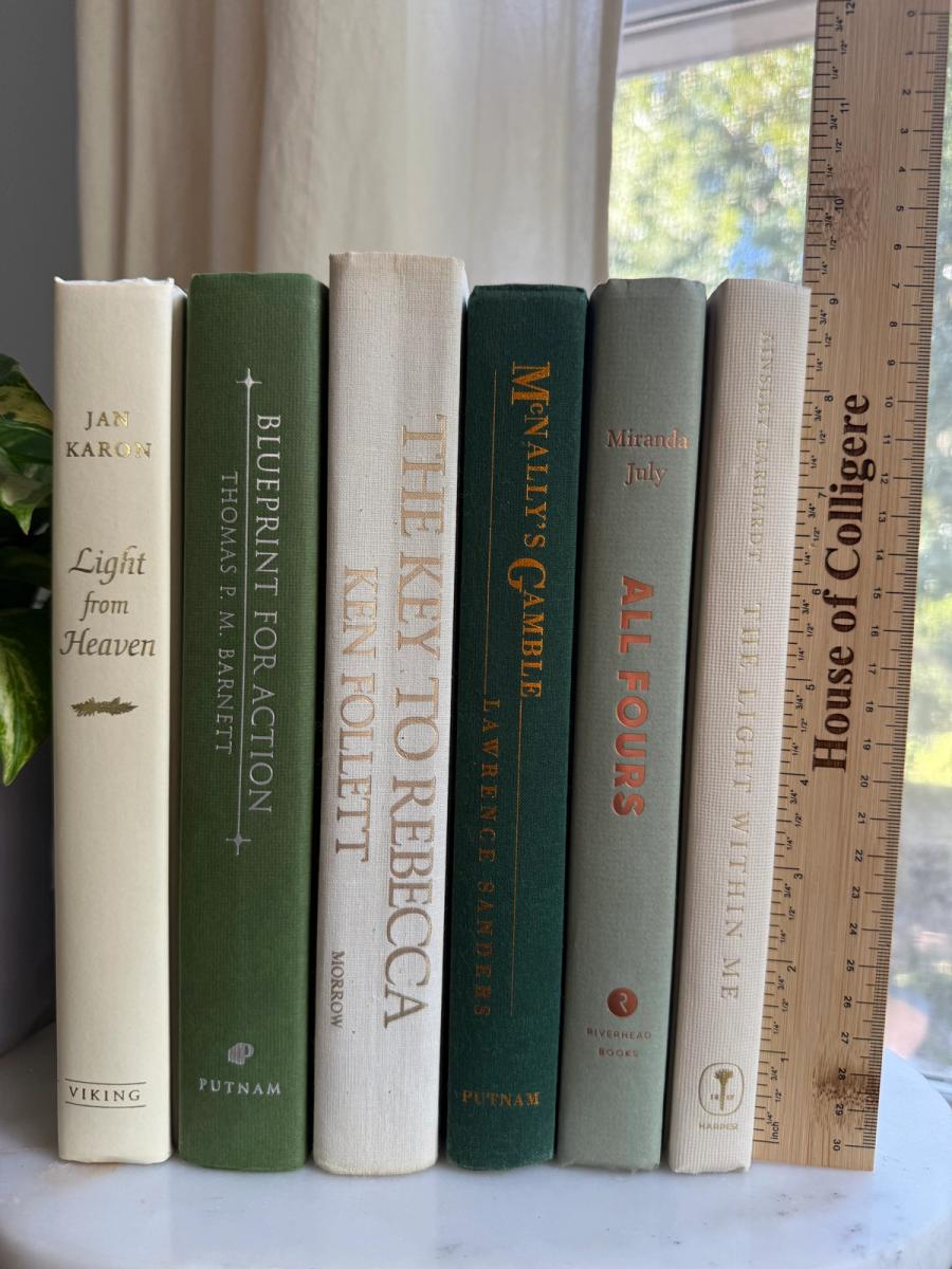 Curated collection of soft sage, olive, cream, and muted green books with botanical tones.