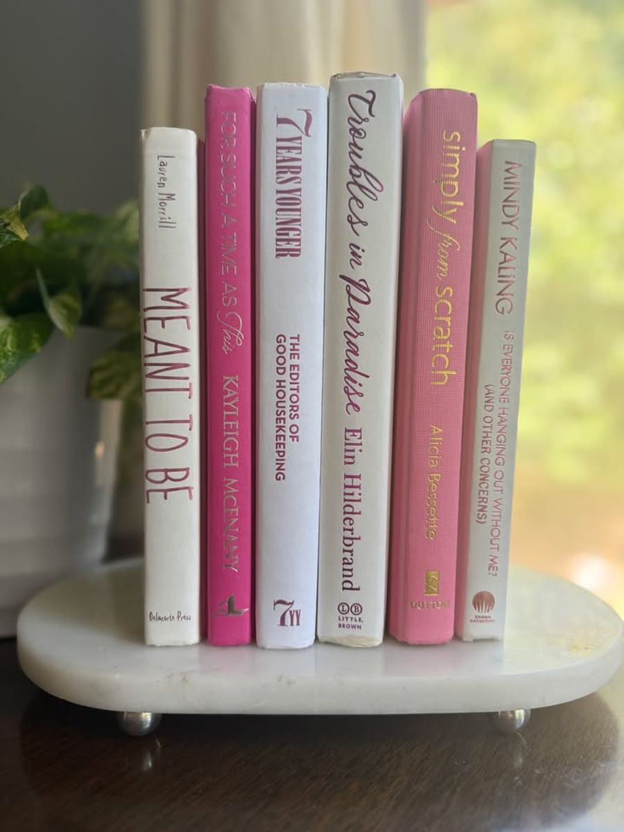 Modernist Edit No. 9 decorative book collection in vivid pink, white, and soft blush tones, tied with neutral linen ribbon and styled on a marble table.