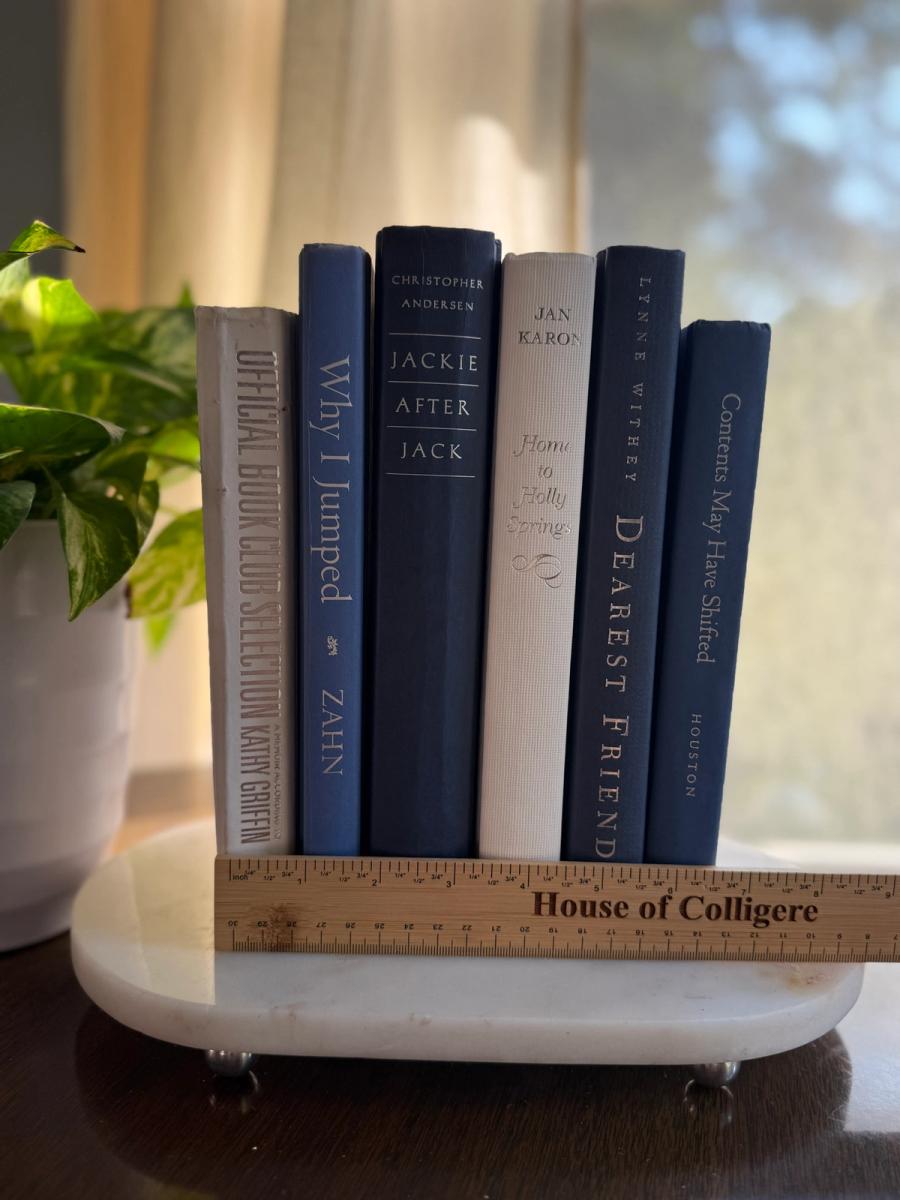 Curated collection of layered blue books ranging from pale coastal blue to deeper ocean tones.