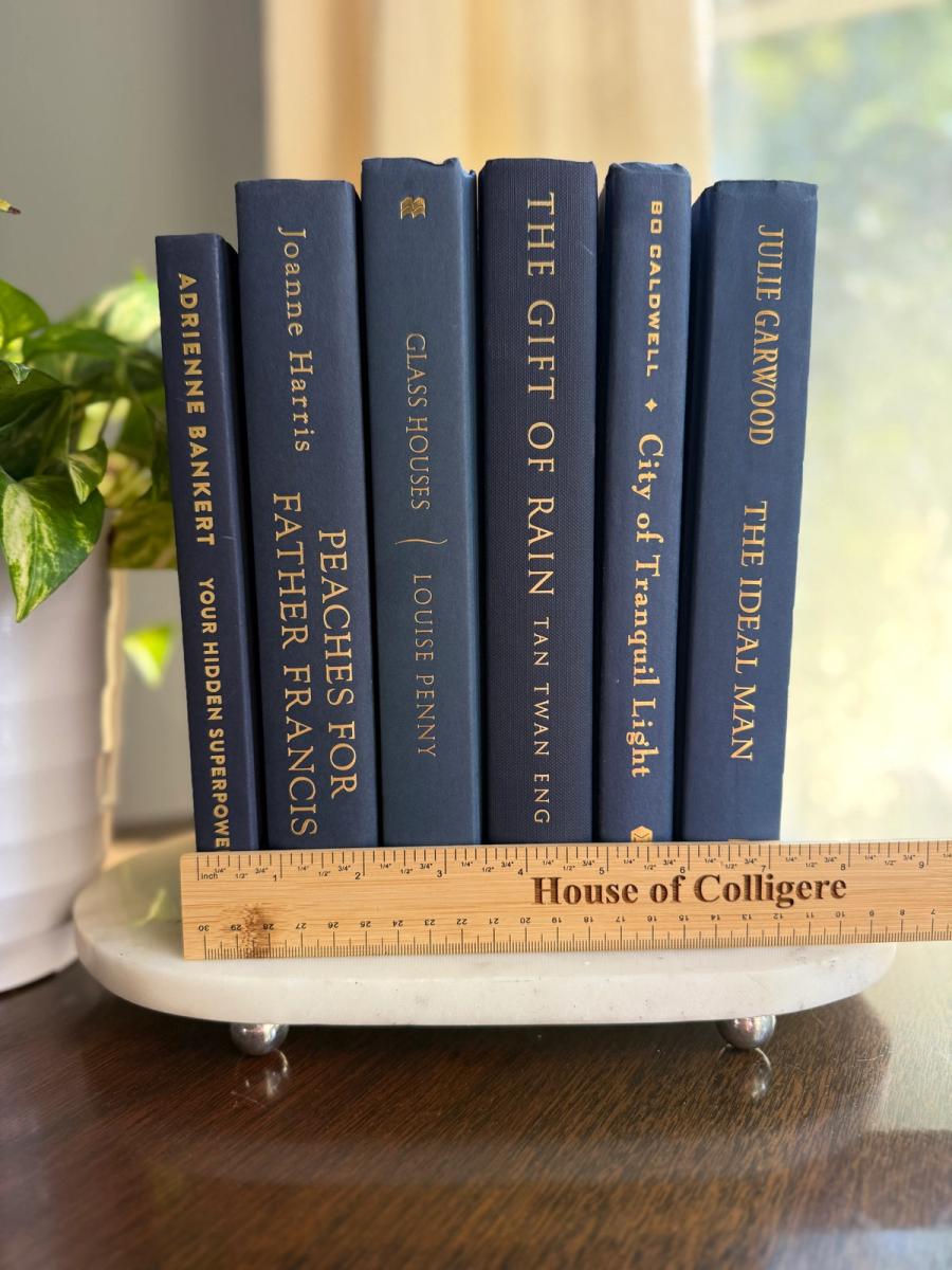 Curated collection of deep navy, warm ivory, brown, and gold-accented books with classic traditional character.