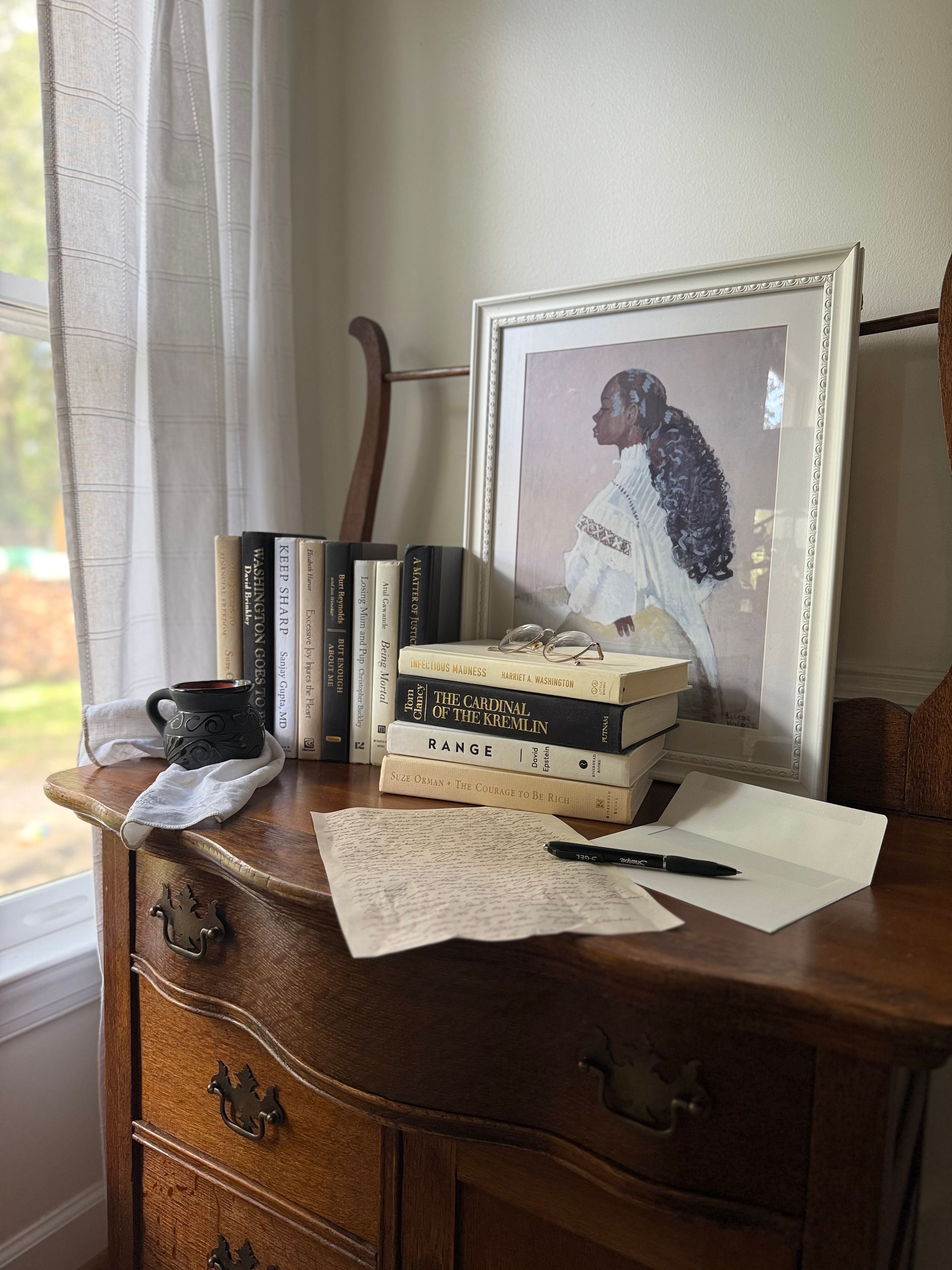 Curated collection of parchment, cream, warm beige, and black books with soft neutral contrast and classic detailing.