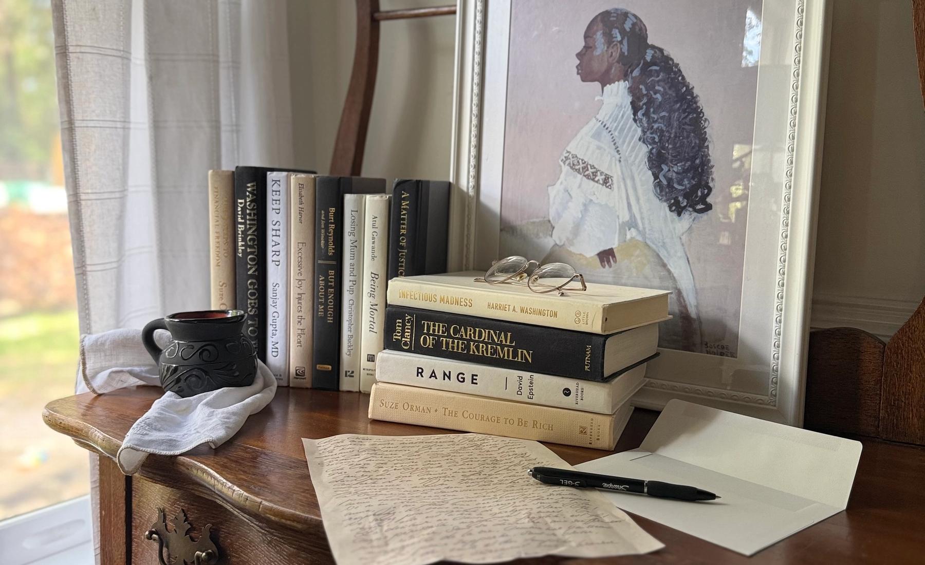 Curated collection of parchment, cream, warm beige, and black books with soft neutral contrast and classic detailing.