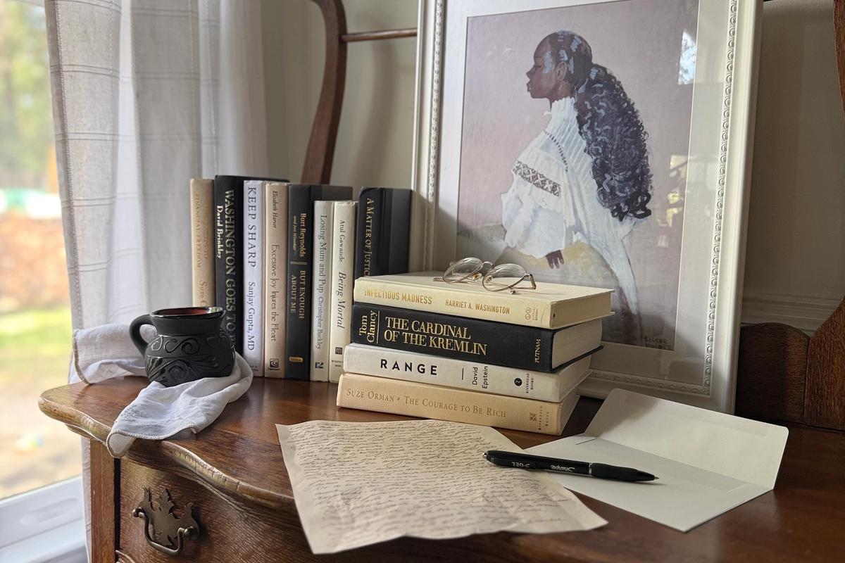 Curated collection of parchment, cream, warm beige, and black books with soft neutral contrast and classic detailing.