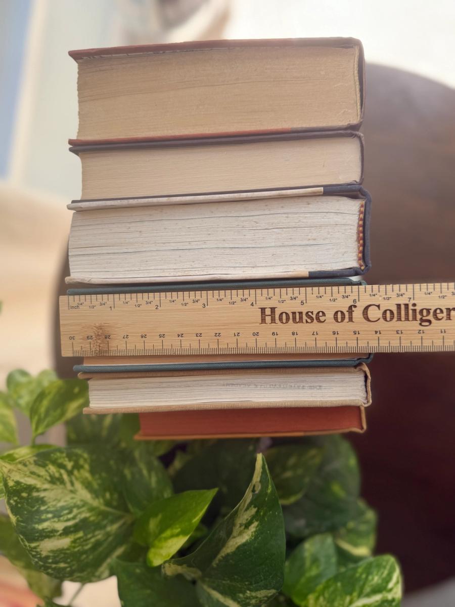 Curated collection of rich brown, hunter green, deep navy, and warm ivory books with classic gold accents.