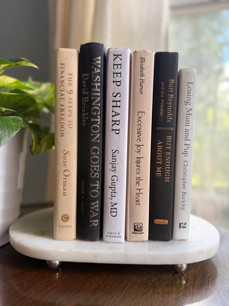 Curated collection of parchment, cream, warm beige, and black books with soft neutral contrast and classic detailing.