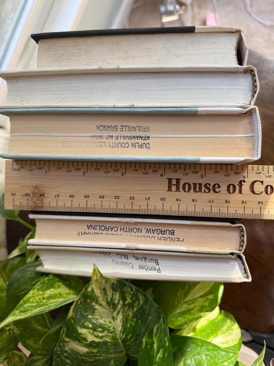 Curated collection of parchment, cream, warm beige, and black books with soft neutral contrast and classic detailing.