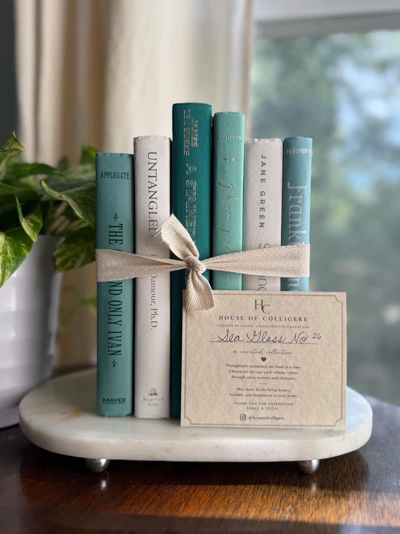 Curated collection of soft blue, aqua, seafoam, and muted coastal-toned books.