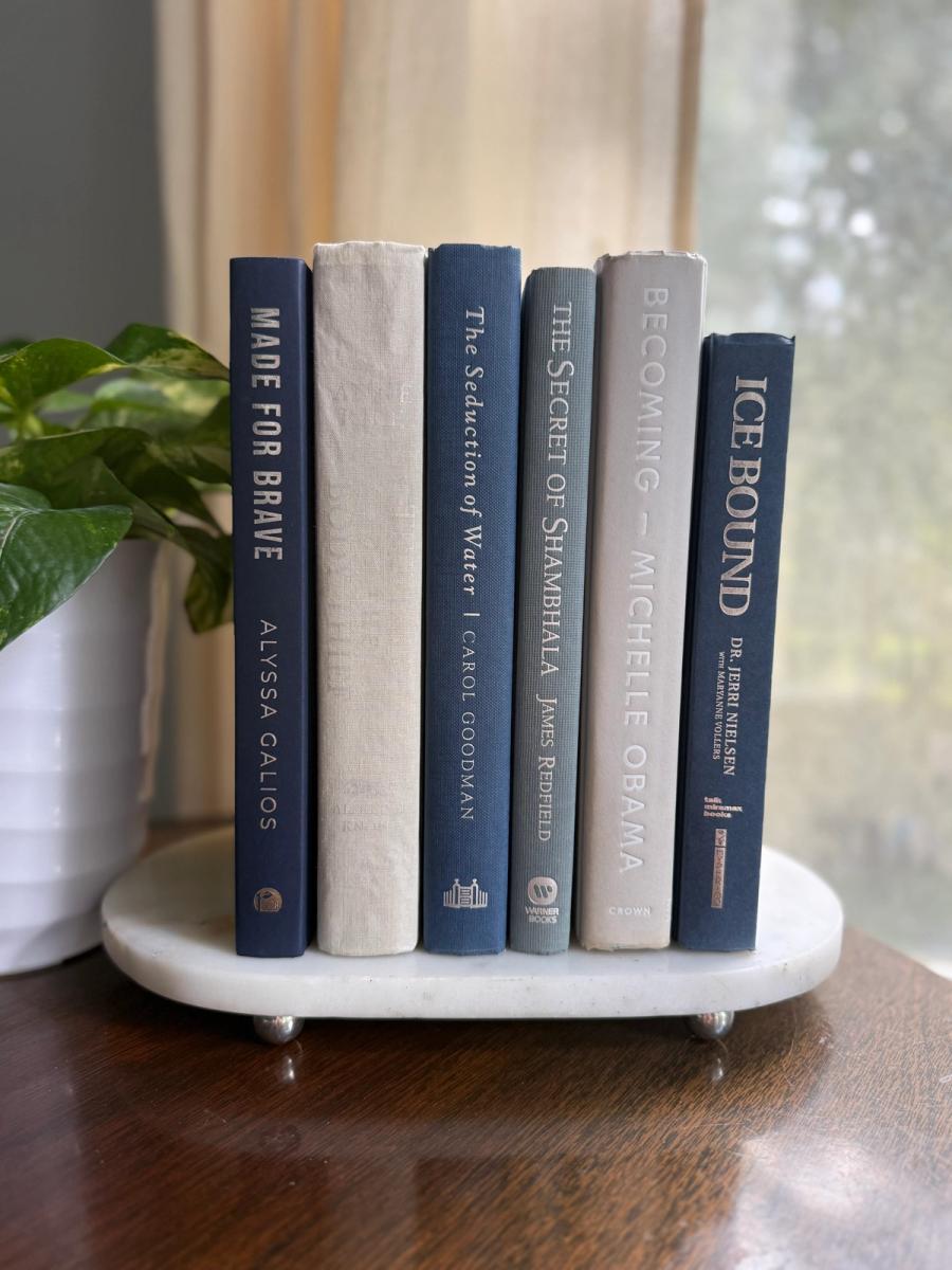 Curated collection of muted blue-gray, slate, charcoal, and softly weathered neutral books.