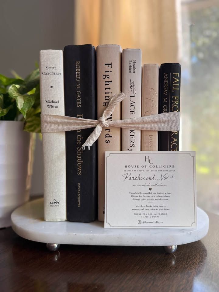 Curated collection of parchment, cream, warm beige, and black books with soft neutral contrast and classic detailing.