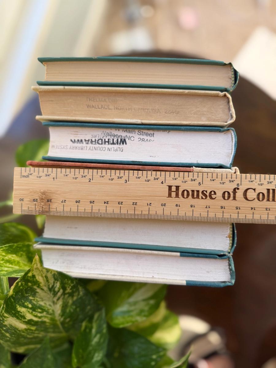 Curated collection of white, pale blue, sand, and soft coastal-neutral books with an airy, sun-faded look.