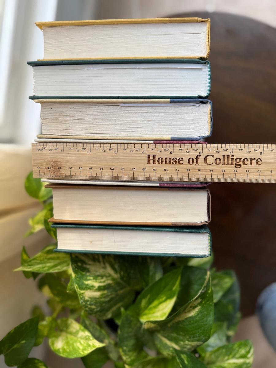 Curated collection of rich brown, hunter green, deep navy, and warm ivory books with classic gold accents.