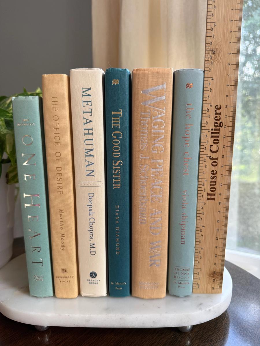 Curated collection of white, pale blue, sand, and soft coastal-neutral books with an airy, sun-faded look.