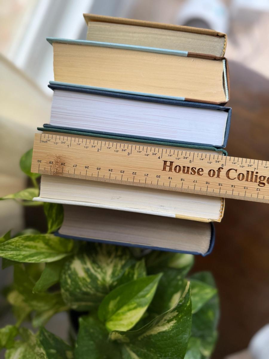 Curated collection of rich brown, hunter green, deep navy, and warm ivory books with classic gold accents.