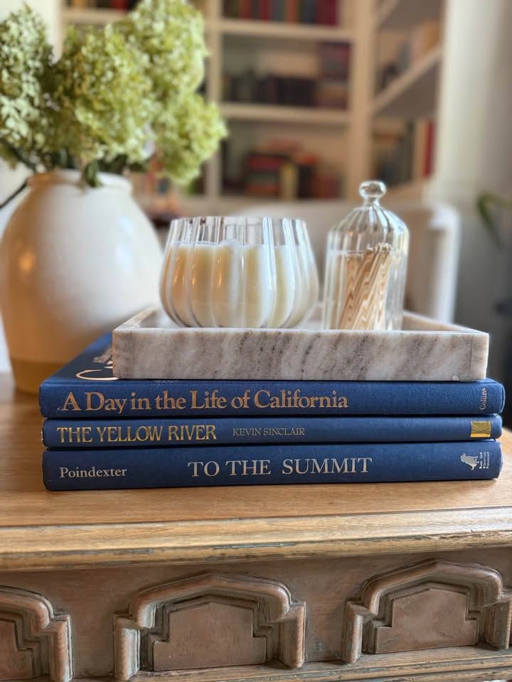 Blue, linen-like cloth covers, matte woven texture, subtle gold and metallic lettering, understated traditional styling