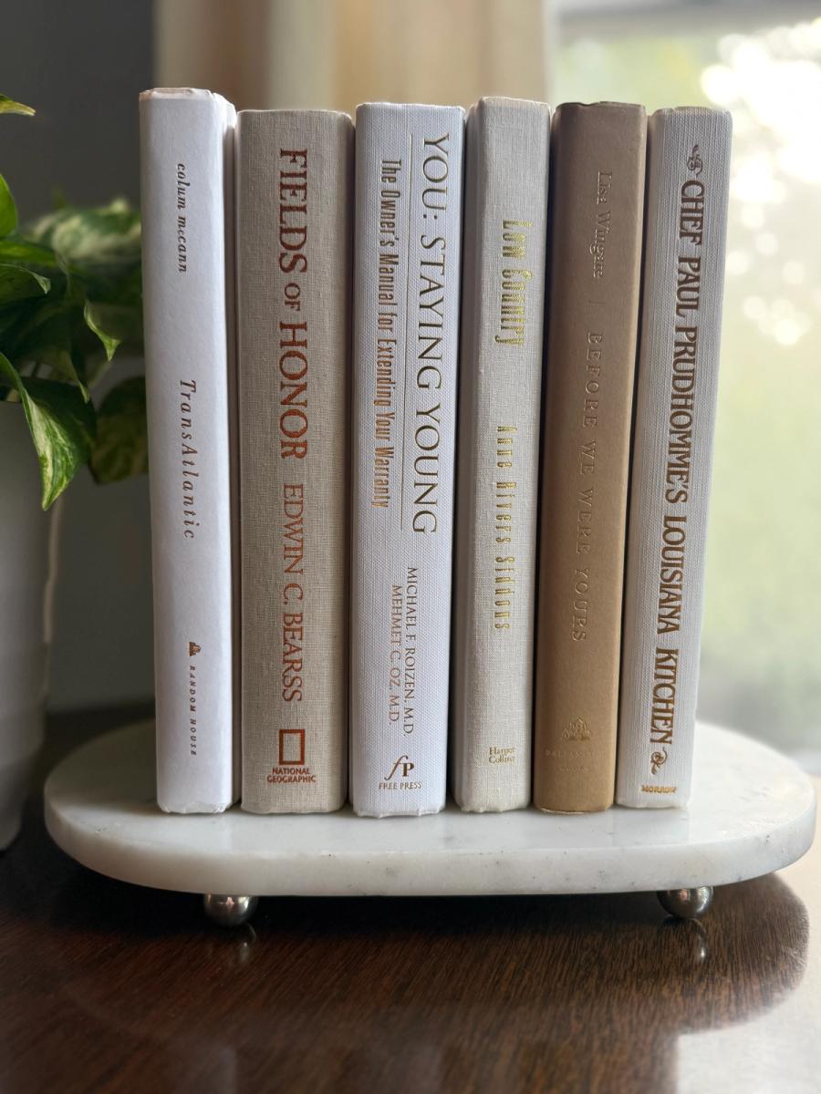 Curated collection of crisp white, ivory, and warm cream books with soft neutral tones.