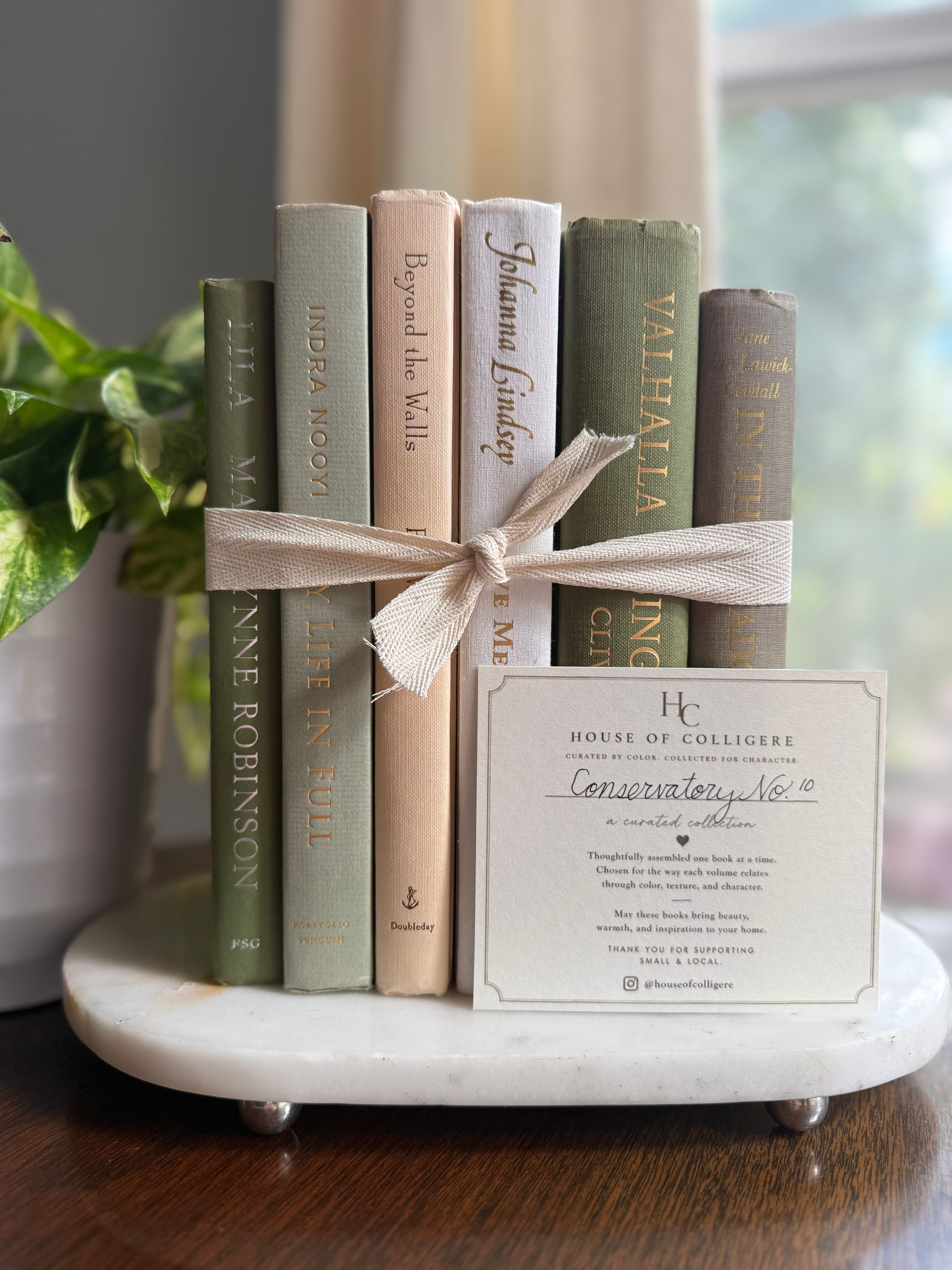 Curated collection of green books ranging from soft sage and olive to deeper botanical tones.