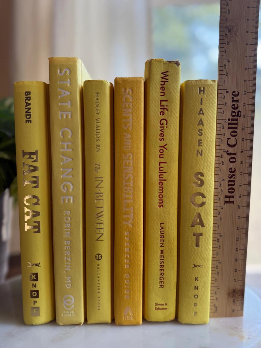 Curated collection of six mustard and golden yellow hardcover books tied with natural cotton ribbon, styled on a marble tray with a House of Colligere Modernist Edit No. 4 collection card.