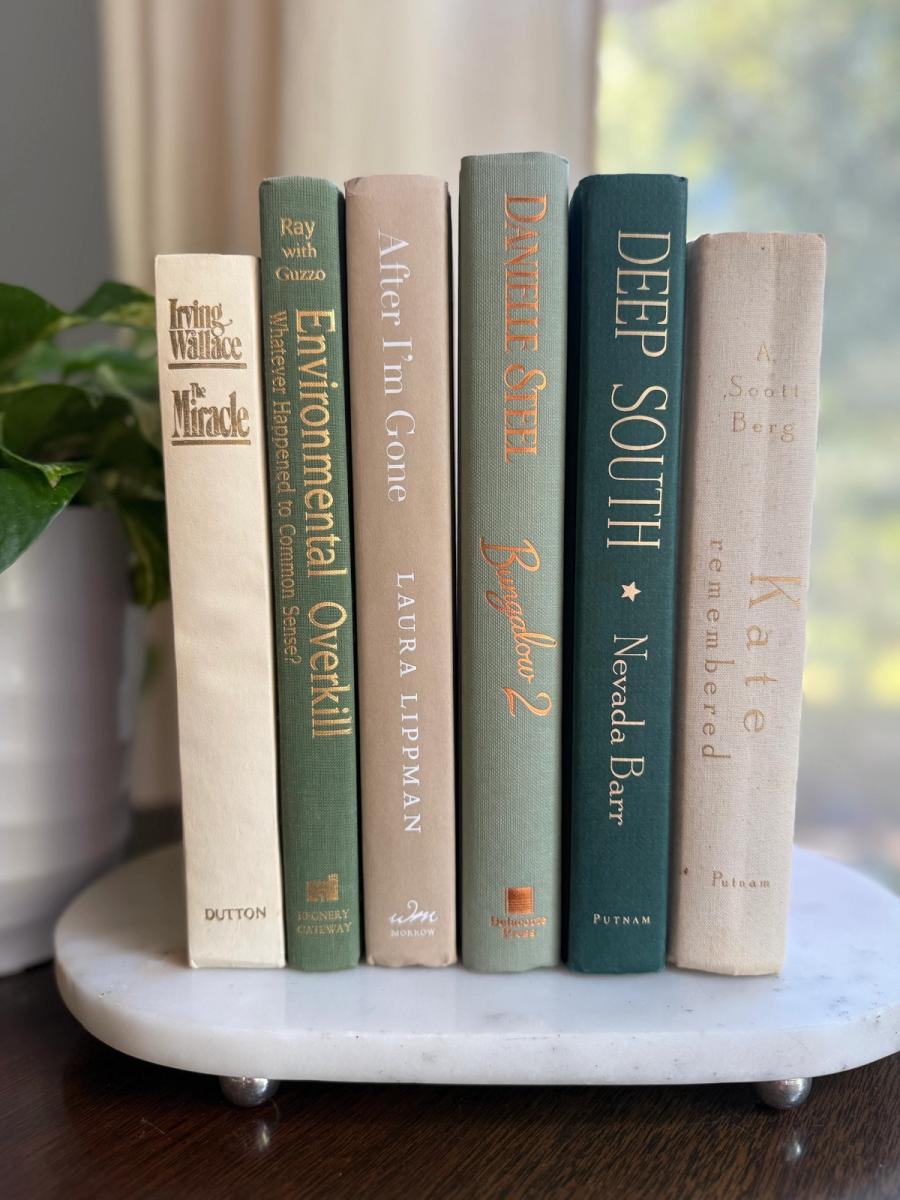 Curated collection of soft sage, olive, cream, and muted green books with botanical tones.