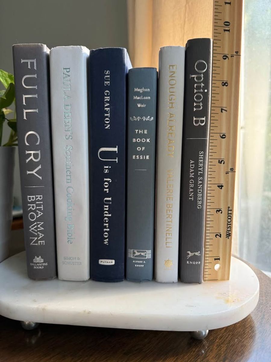 Curated collection of muted blue-gray, slate, charcoal, and softly weathered neutral books.