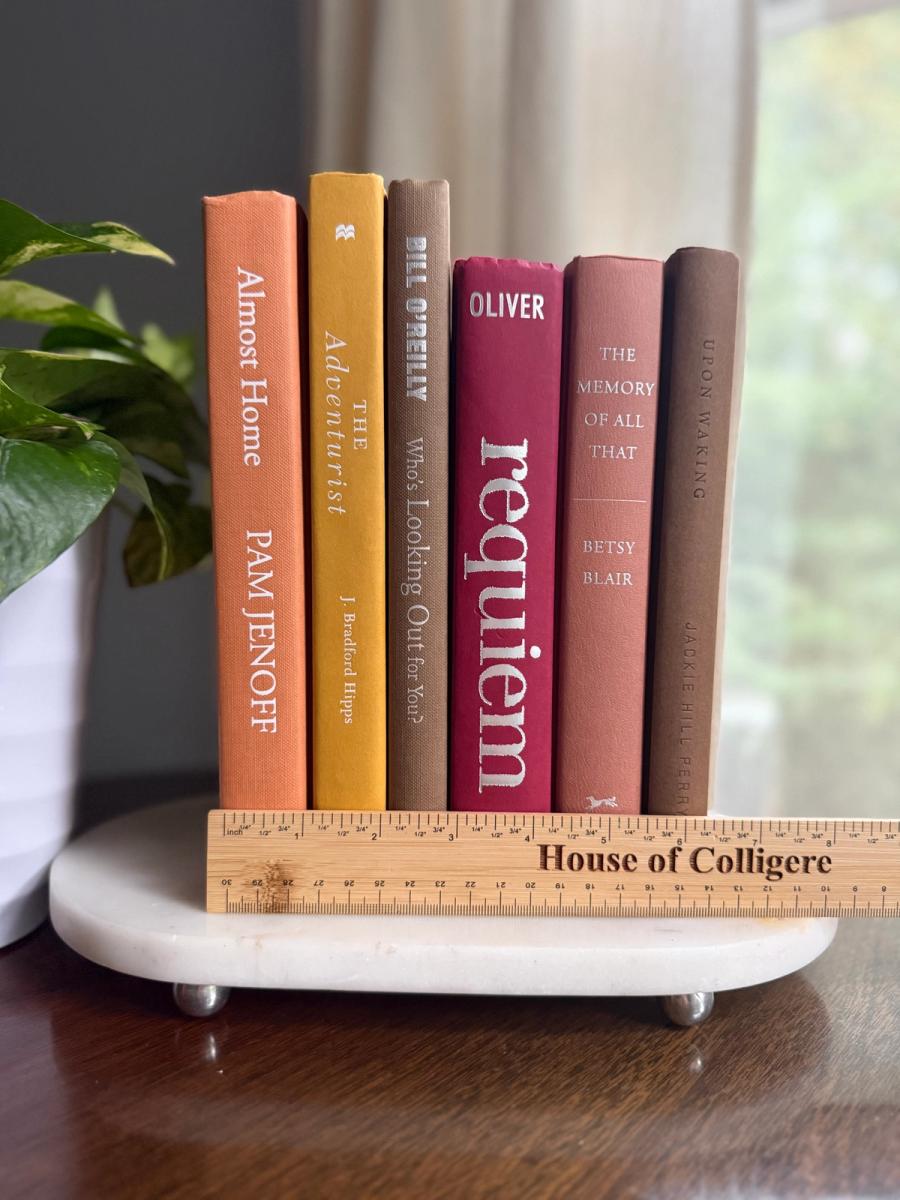 Curated collection of dusty rose, plum, warm brown, taupe, and muted berry-toned books with soft vintage character.