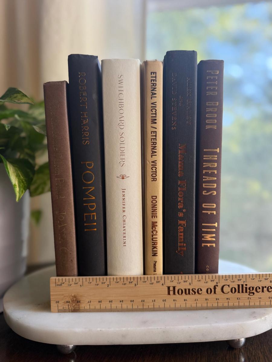 Curated collection of warm brown, olive, tan, and aged neutral books with a traditional library palette.
