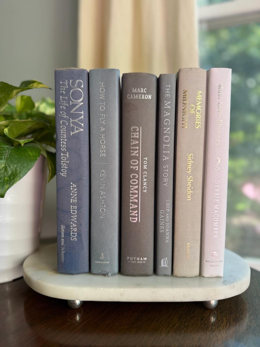 Curated collection of muted blue-gray, slate, charcoal, and softly weathered neutral books.