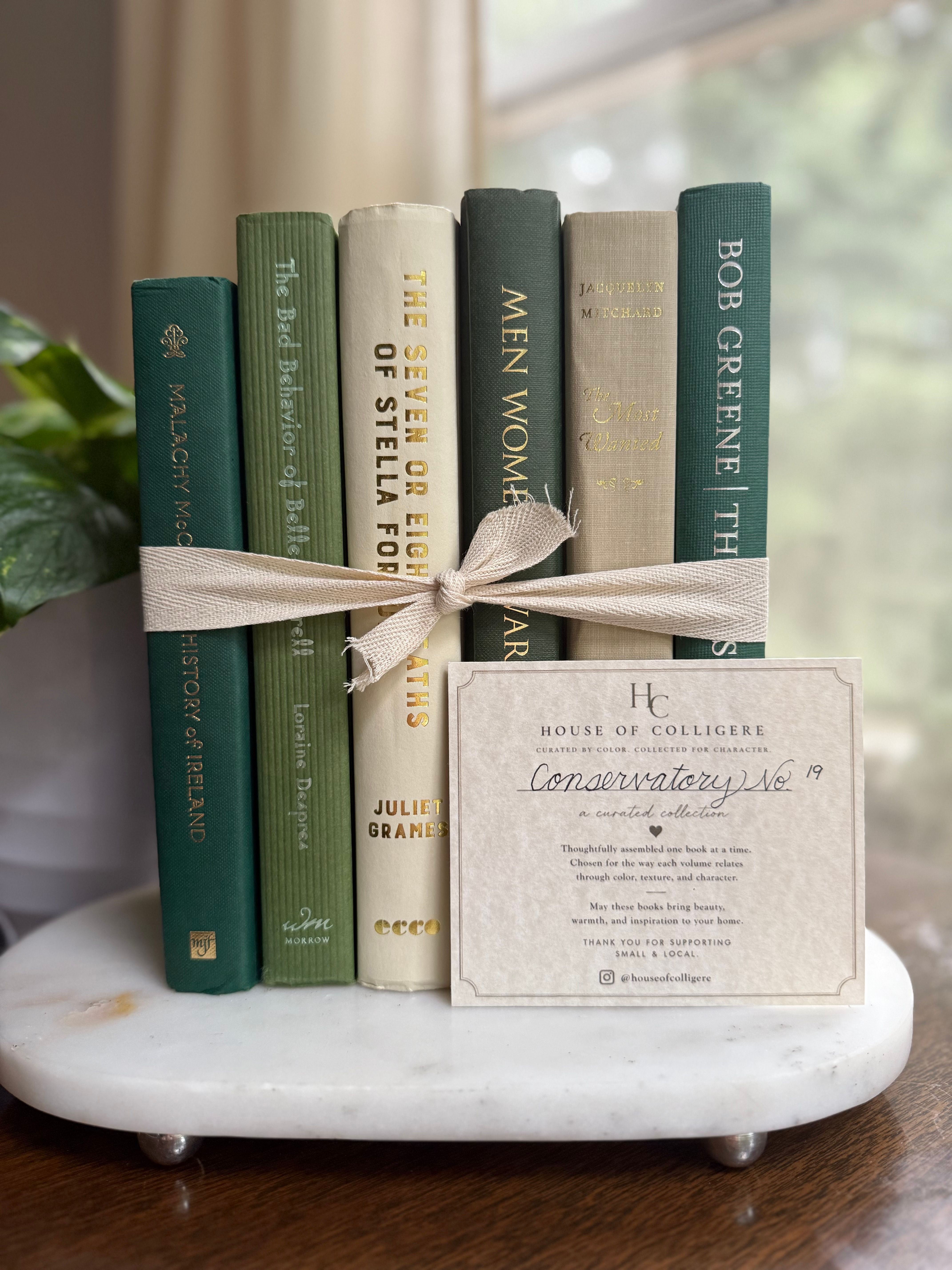 Curated collection of soft sage, olive, cream, and muted green books with botanical tones.