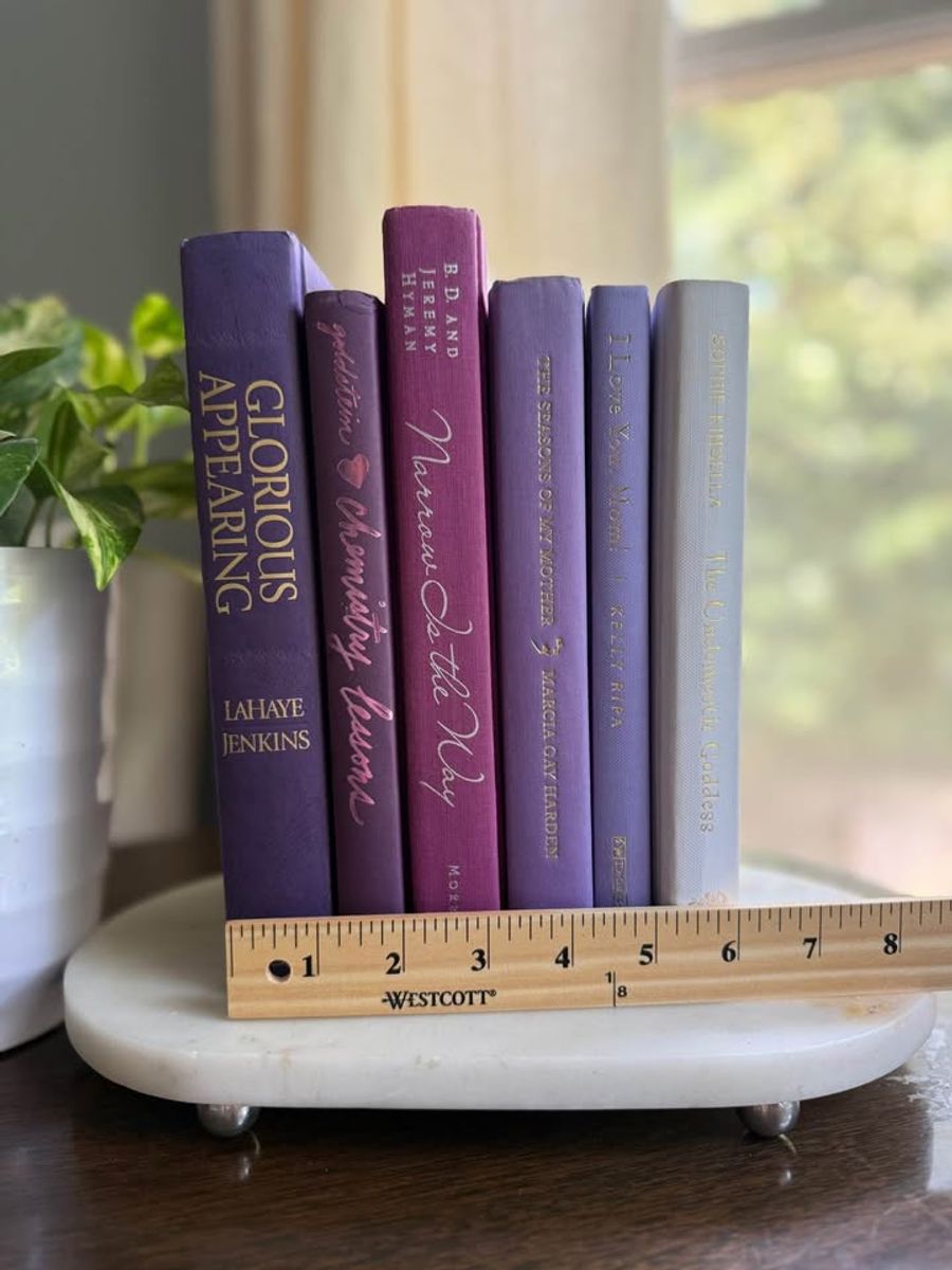 Curated collection of lavender, lilac, orchid, and violet books with soft tonal variation and floral-inspired color.